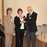 Bill Gill presents a commemorative plaque to two of Bert Cooke's daughters